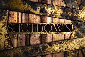 Shutdown text formed with real authentic typeset letters on vintage textured silver grunge copper and gold background