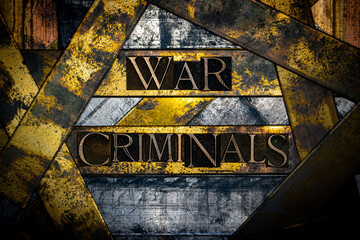 War Criminals text formed with real authentic typeset letters on vintage textured silver grunge copper and gold background