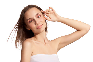 Sensual pretty woman with beautiful short brown hairs on wind, posing isolated on white. Close portrait of a girl with natural makeup.