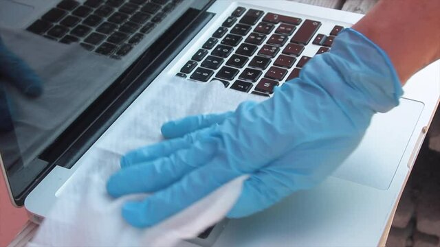 virus sanitization on the computer keyboard with blue spray jet screen and sanitizing wipe