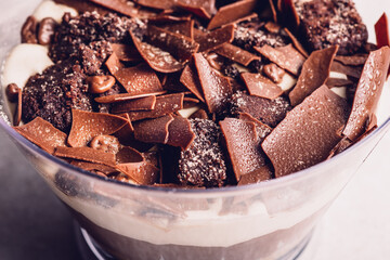 Family Pot of Irresistible Layered Billionaires Dessert made from chocolate and caramel mousse layers, chocolate brownie bites and crunchy chocolate honeycomb pieces. Finished with choco chunks
