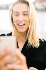 Young attractive woman using phone in city.