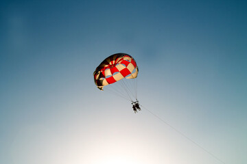 Paraglider soaring over the seashore