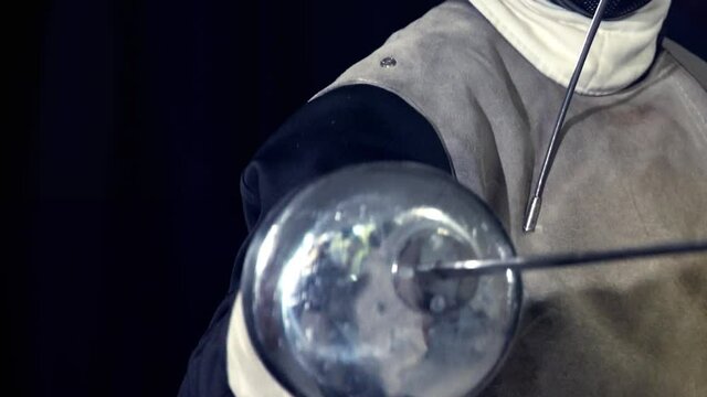 Fencing class in epee for women. Sport girl fence with her coach attacks in hand maestro individual lesson close up.
