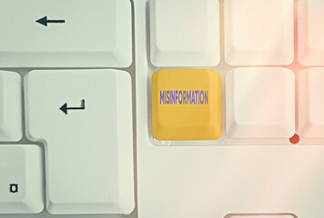 Writing note showing Misinformation. Business concept for false data, in particular, intended...