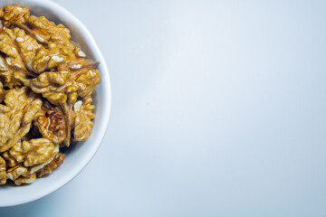 Walnuts in the bowl on the white background