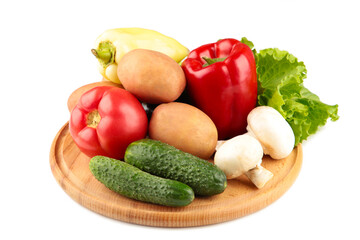 Image of a variety of colorful vegetables on a cutting board isolated on white background