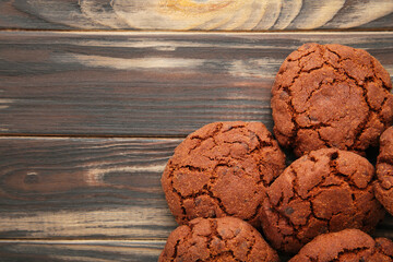 Chocolate chips cookies on brown background with copy space