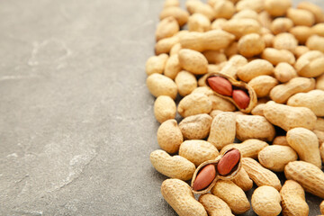 Peanuts in shells on grey background with copy space