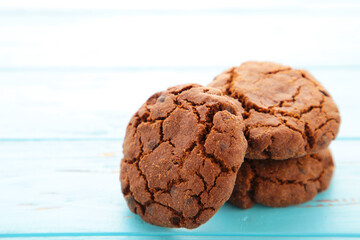 Chocolate chips cookies on blue background with copy space