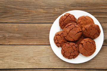 Chocolate chip cookies on a plate on grey wooden background