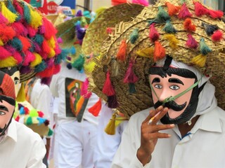  man smoking in a carnival costume