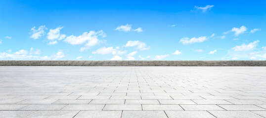 Empty square floor and blue sky with white clouds scene.