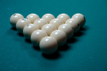 Pyramid, balls placed on a pool table tightly to each other in the form of an equilateral triangle front view from the top
