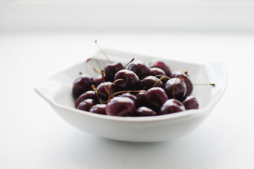 cherries in bowl on the white background