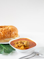 Singapore Curry Chicken Flatlay With Bread. Curry Chicken on White Background. Chinese Curry Served With Bread.