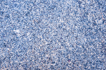 Beautiful stone granite background - polished stone surface with grainy texture with grains of blue, purple, pink color