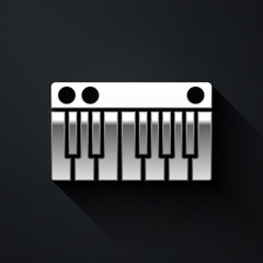 Silver Music synthesizer icon isolated on black background. Electronic piano. Long shadow style. Vector Illustration.