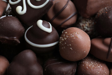 Obraz na płótnie Canvas Different tasty chocolate candies as background, closeup