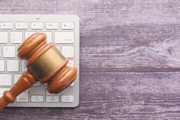 Top view of gavel on keyboard on table 