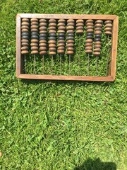 wooden abacus on the green grass