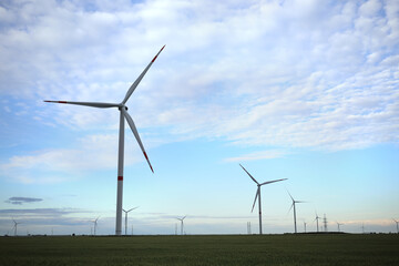 Beautiful view of field with wind turbines. Alternative energy source