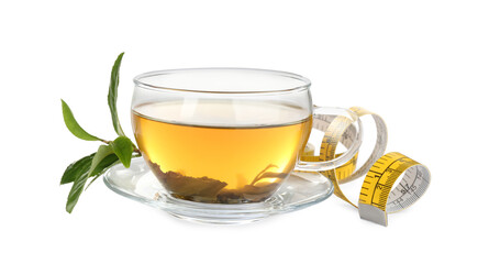 Glass cup of diet herbal tea, green leaves and measuring tape on white background