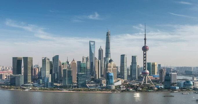 time lapse of shanghai skyline, aerial view of pudong financial center and huangpu river against a blue sky, China.