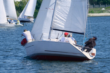 Crew of yachtsmen conducting a flanking manoeuvre, sailing yacht turning