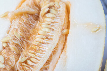 The melon is cut into two parts. Close-up of melon seeds.