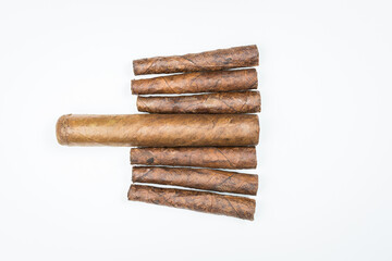 Big and small cigars twisted from sheets of tobacco on white background.