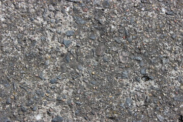 Gray concrete texture with pebbles background
