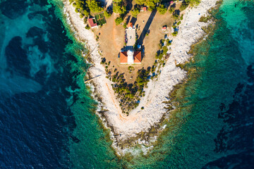 Lighthouse of Veli Rat on the island of Dugi Otok, Croatia, beautiful seascape and rocks, overhead view from drone