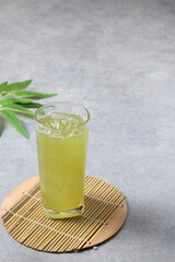Iced green tea placed on a cement table