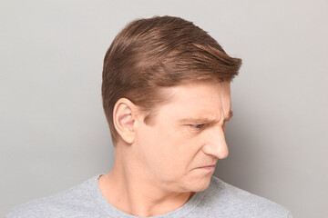 Obraz premium Portrait of angry disgruntled mature man with frowning face