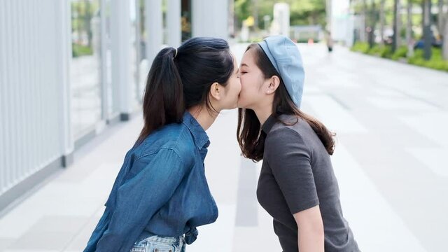 Young asian lesbian LGBT couple moments happiness concept.Funny women friends kiss . LGBT Lesbian couple together outdoor concept.