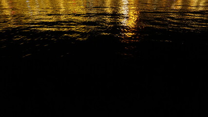 Gold color reflection on sea at night, background