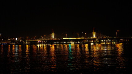 Fototapeta na wymiar Golden Horn Metro Bridge in Istanbul at night, black sky and sea, Gold color reflection, background