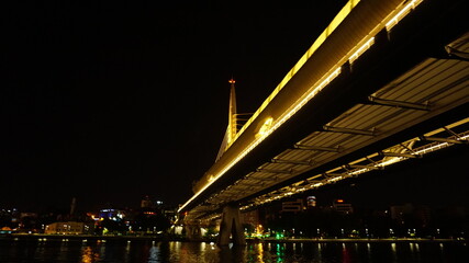 Fototapeta na wymiar Golden Horn Metro Bridge in Istanbul at night, black sky and sea, Gold color reflection, background