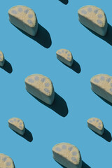 Pattern of tasty marshmallows with hard shadows on a light blue background with copy space