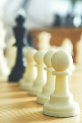 chess pawns lined up in a row , Leader success concept