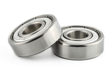 Macro shot of two ball bearings, isolated on a white background, selective focus.