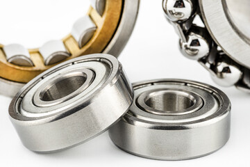 Macro shot of two ball bearings, isolated on a white background, selective focus.