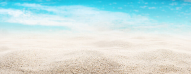 Fototapeta na wymiar Sea panorama with sandy beach White sandy beach with a sea view. Close-up with short depth of field and space for text. Background for a tourism concept or summer vacation and travel.