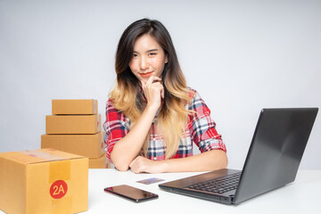 Asian women are starting a new business in the online market. Asian women checking products, preparing to deliver products to customers. SME Concept