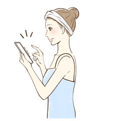 スマホを操作して笑顔な女性の横顔