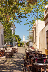 A beautiful street with empty tables and restaurants in the city of Colonia del Sacramento, a cozy city in Uruguay, close to the River Plate, with tourist sites, such as a lighthouse and museums.