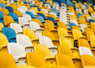Free seats on stadium. Yellow, blue, white