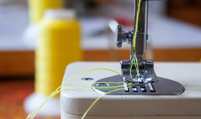 sewing machine foot and needle. Close up, macro. Empty space for text. Craft fabric industrial.