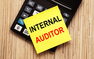 calculator with text INTERNAL AUDITOR with yellow paper